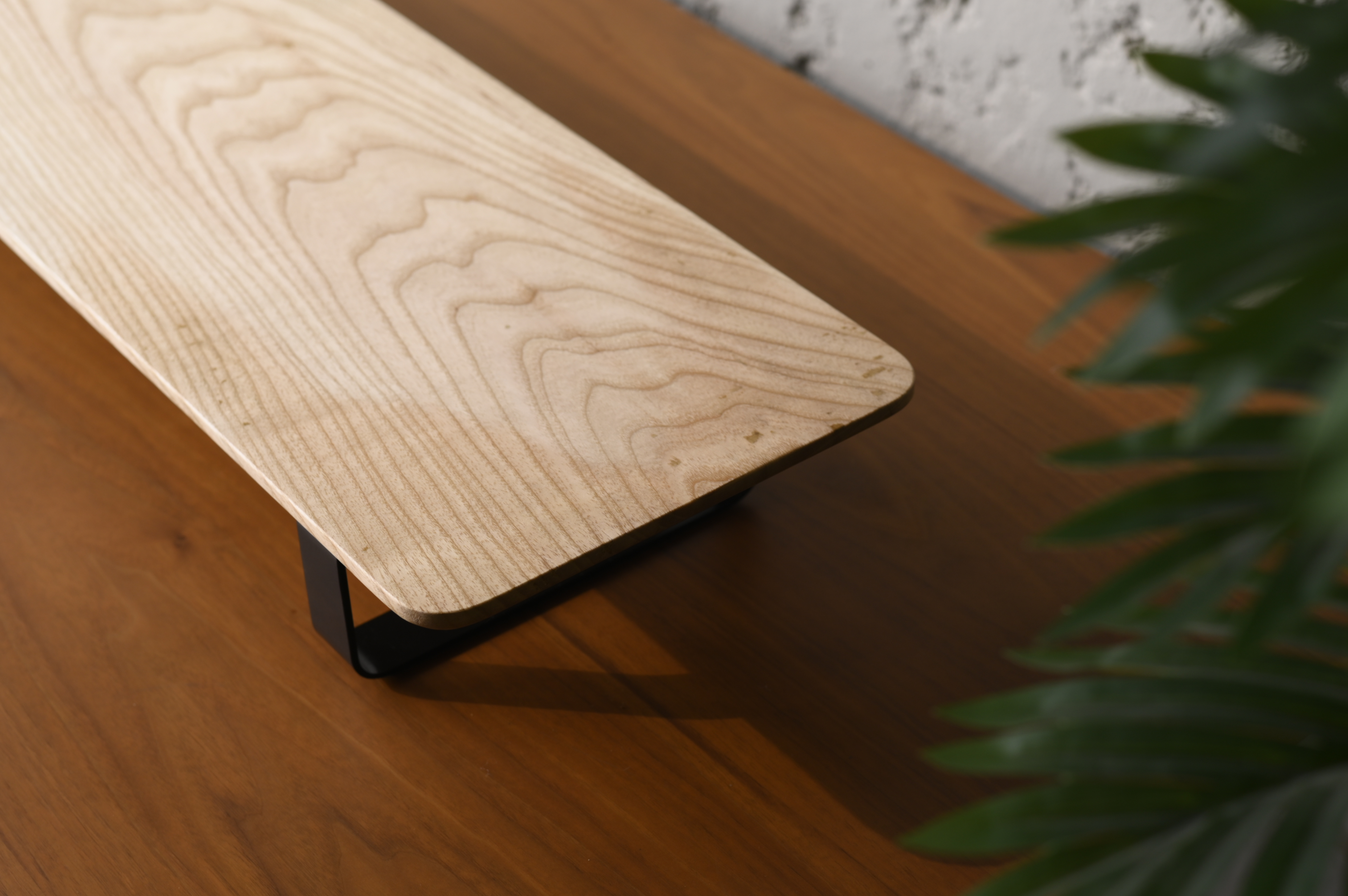Wooden desk with black metal legs on a wooden floor